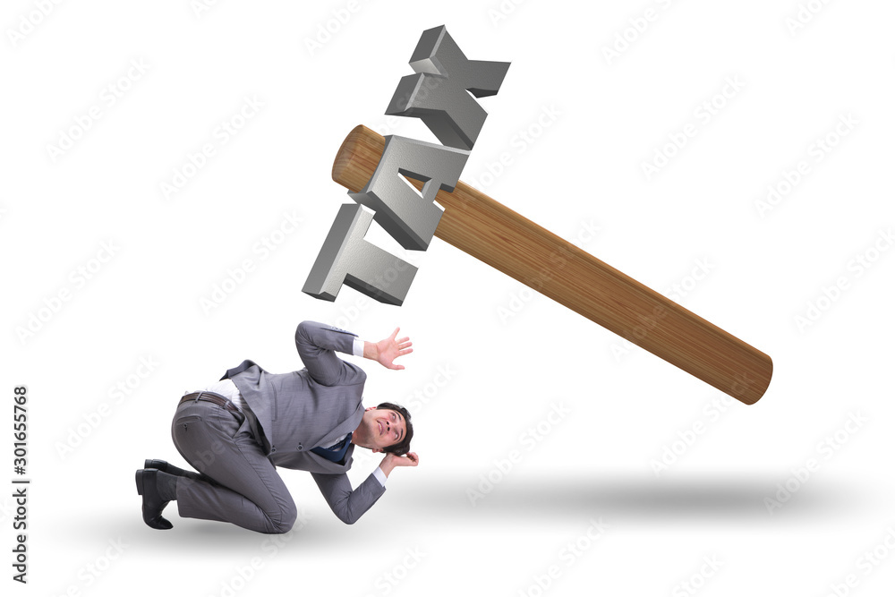 Businessman under the burden of tax payments Businessman under the burden of tax payments
