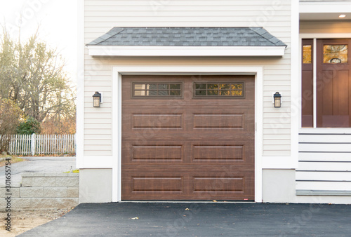 GARAGE DOOR in a traditional single house painted in brown color 