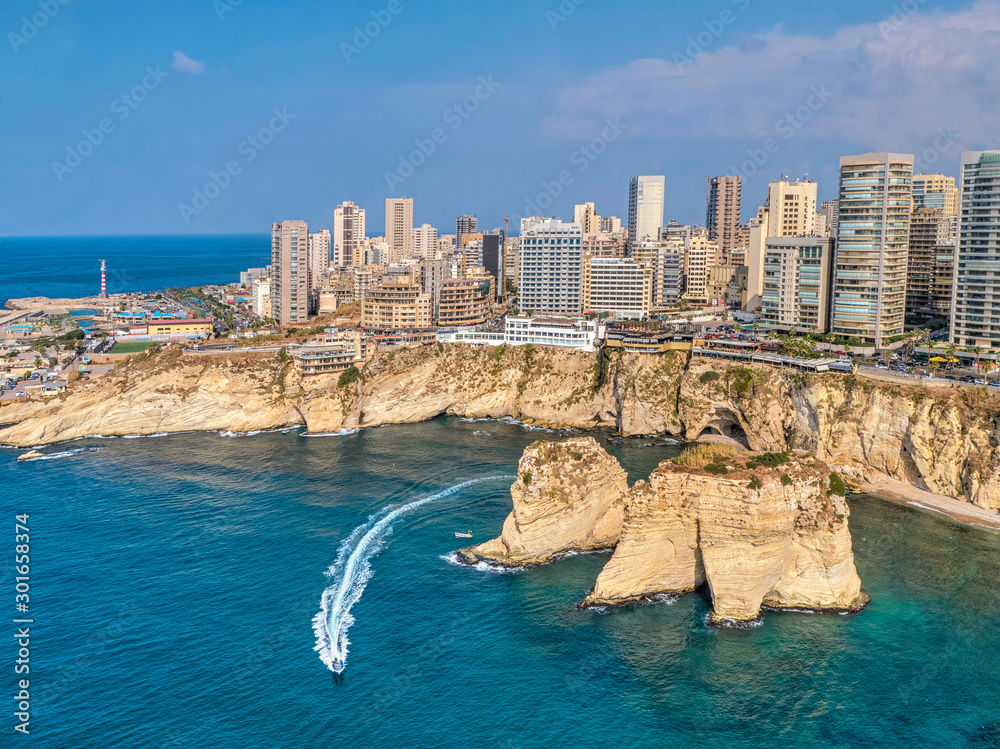 Obraz premium Rouche rocks in Beirut, Lebanon in the sea during daytime. Pigeon Rocks in Mediterranean sea.