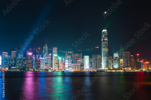 Hong Kong night skyline with laser at Victoria Harbour.