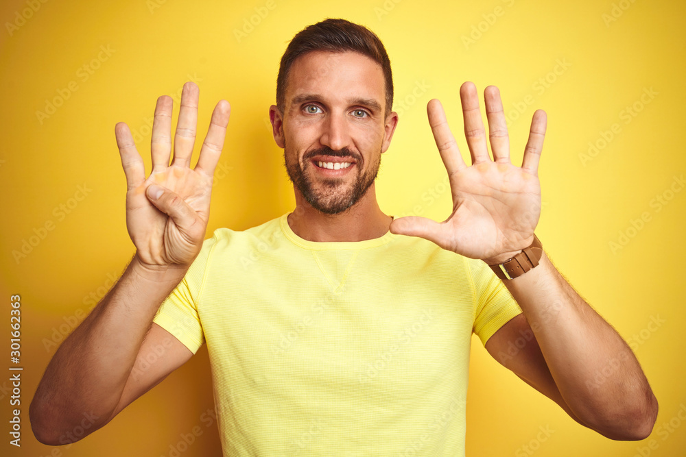 Young handsome man wearing casual yellow t-shirt over yellow isolated background showing and pointing up with fingers number nine while smiling confident and happy. Young handsome man wearing casual yellow t-shirt over yellow isolated background showing and pointing up with fingers number nine while smiling confident and happy.