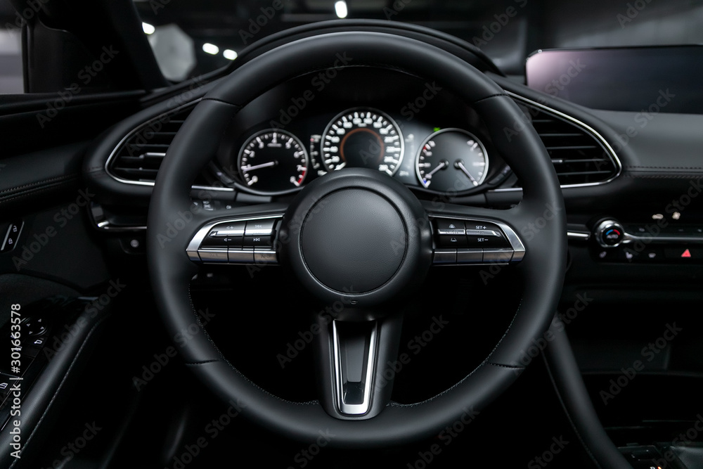close-up of the dashboard, player, steering wheel, buttons. modern car interior: parts, buttons, knobs.