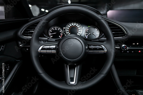 close-up of the dashboard, player, steering wheel, buttons. modern car interior: parts, buttons, knobs. © Виталий Сова