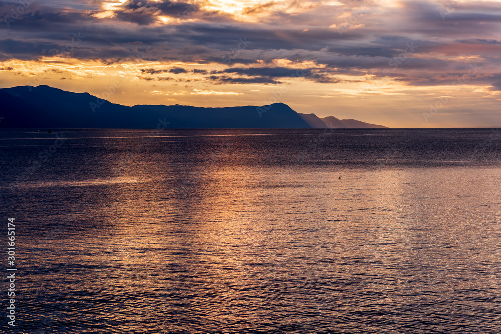 View of ocean sunset over mountains in beautiful British Columbia.
