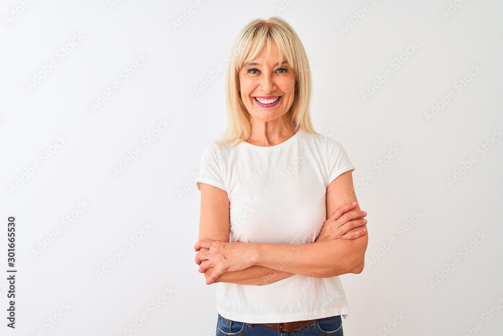 Middle age woman wearing casual t-shirt standing over isolated white background happy face smiling with crossed arms looking at the camera. Positive person. Middle age woman wearing casual t-shirt standing over isolated white background happy face smiling with crossed arms looking at the camera. Positive person.