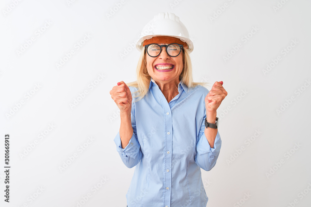 Middle age architect woman wearing glasses and helmet over isolated white background excited for success with arms raised and eyes closed celebrating victory smiling. Winner concept. Middle age architect woman wearing glasses and helmet over isolated white background excited for success with arms raised and eyes closed celebrating victory smiling. Winner concept.