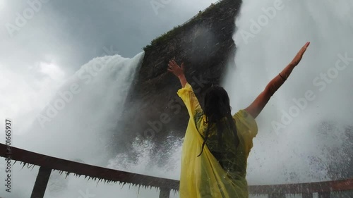 Traveler enjoys waterfall in Cave of the Winds under the Niagara Falls, watered down by waterfall, incredible emotions, travel around the United States
