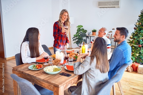 Beautiful family meeting smiling happy and confident. Speaking speech eating roasted turkey celebrating Christmas at home