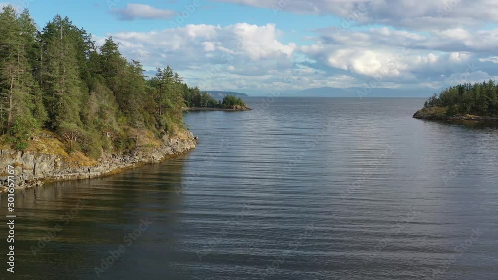 View over inlet, ocean and island with boat and mountains in beautiful British Columbia. Canada. Aerial drone flying. 4K. View over inlet, ocean and island with boat and mountains in beautiful British Columbia. Canada. Aerial drone flying. 4K.