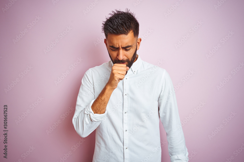Young indian businessman wearing elegant shirt standing over isolated pink background feeling unwell and coughing as symptom for cold or bronchitis. Healthcare concept.