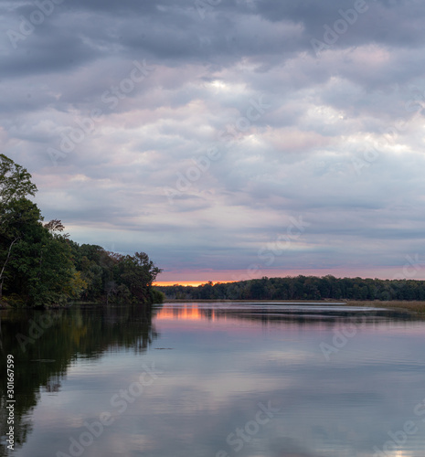Calm River Landscape at Sunrise with Orange and Pink Clouds
