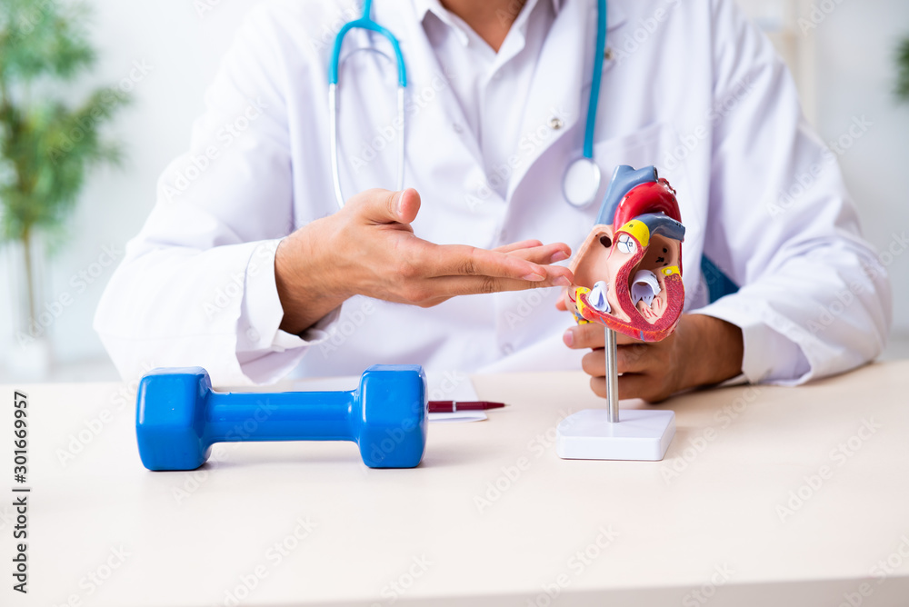 Young male doctor in sport and dieting concept Young male doctor in sport and dieting concept