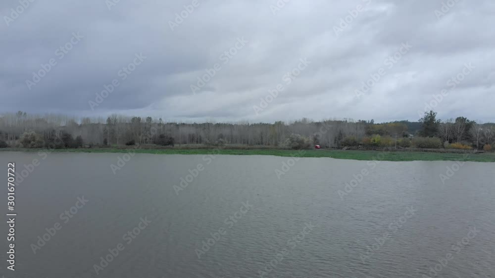 Landscape aerial view of beautiful lake full of water hyacinths on a autumn cloudy day. Van parked near water. Landscape aerial view of beautiful lake full of water hyacinths on a autumn cloudy day. Van parked near water.
