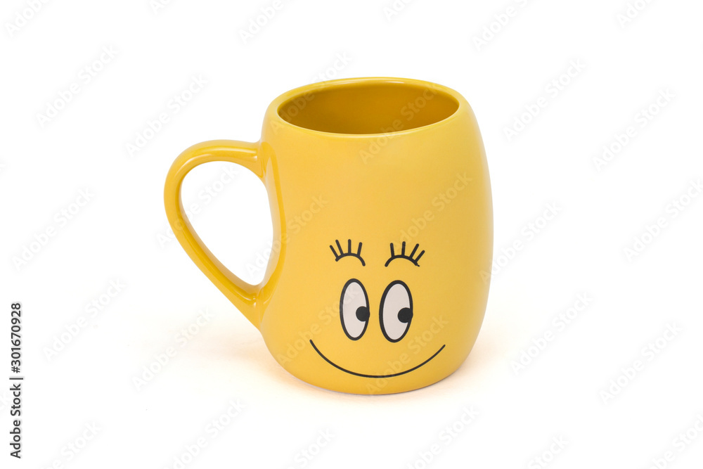 Closeup empty happy yellow smiling cup isolated on white background. Ceramics cup in bean shaped with smile face on mug. Clipping path. Closeup empty happy yellow smiling cup isolated on white background. Ceramics cup in bean shaped with smile face on mug. Clipping path.