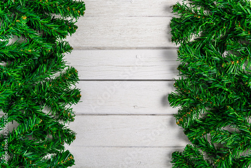 Fir branches on white wooden board