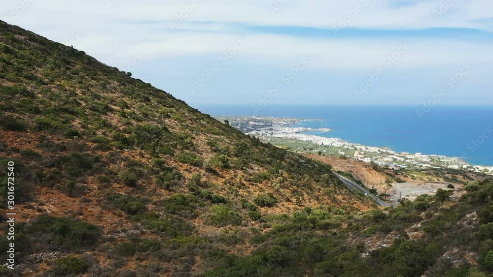 Aerial view of Windy Road in Mountain near Mediterranean Sea. Flying above Mountain Road in Crete, Greece Aerial view of Windy Road in Mountain near Mediterranean Sea. Flying above Mountain Road in Crete, Greece