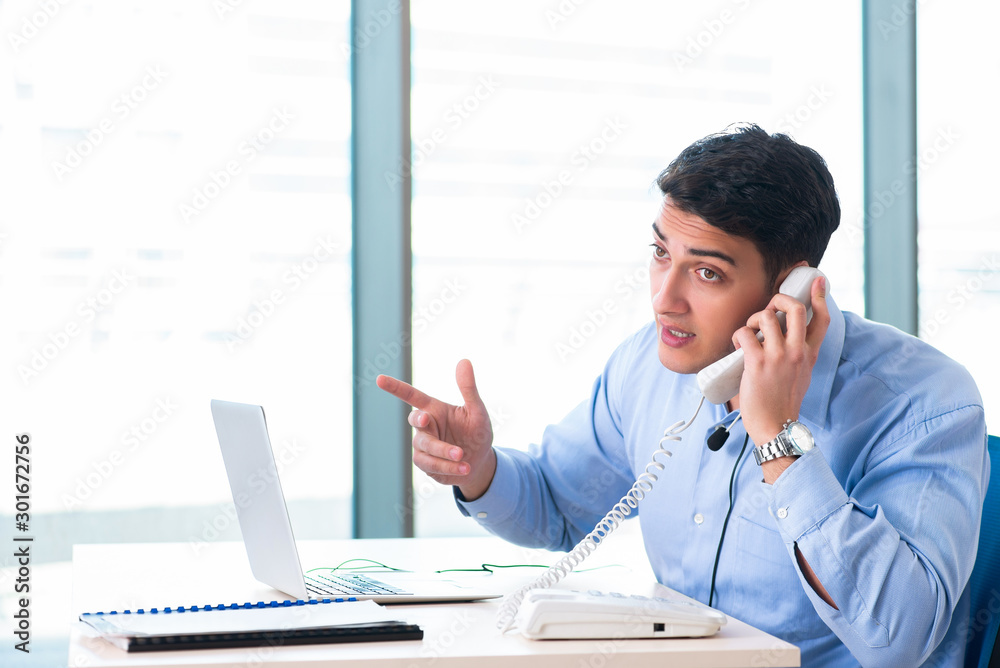 Male call-center operator in business concept Male call-center operator in business concept