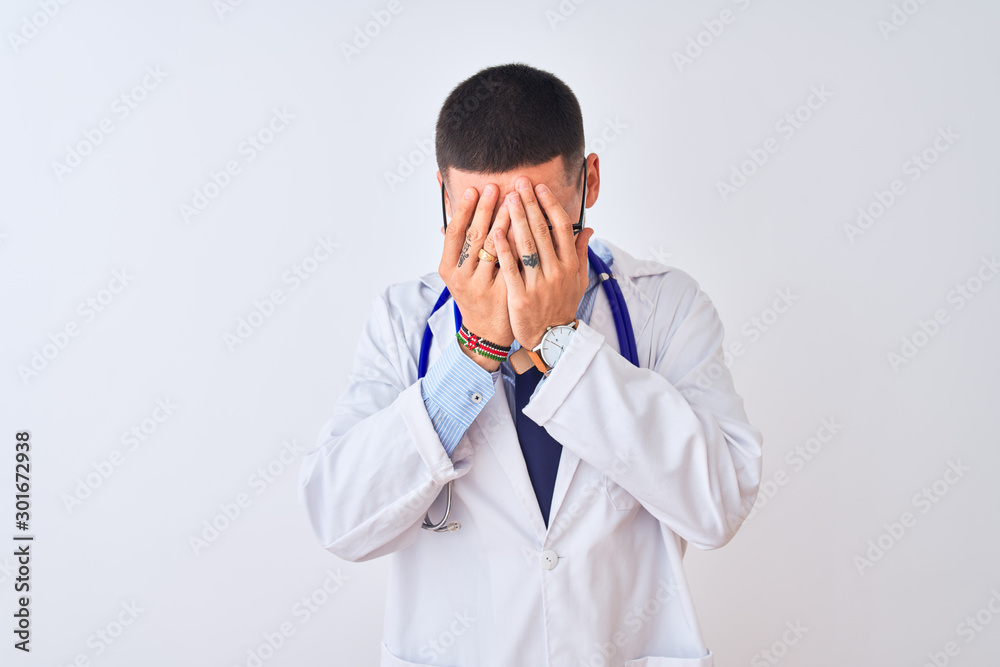 Young doctor man wearing stethoscope over isolated background with sad expression covering face with hands while crying. Depression concept. Young doctor man wearing stethoscope over isolated background with sad expression covering face with hands while crying. Depression concept.
