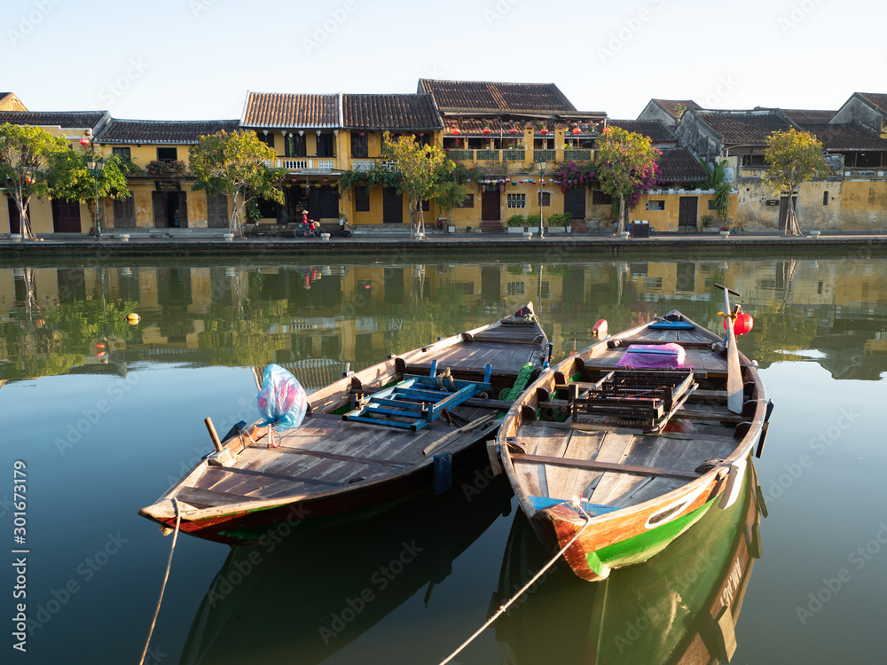 Obraz premium Two Wooden Fishing Boats in the Thu Bon River in Hoi An, Vietnam