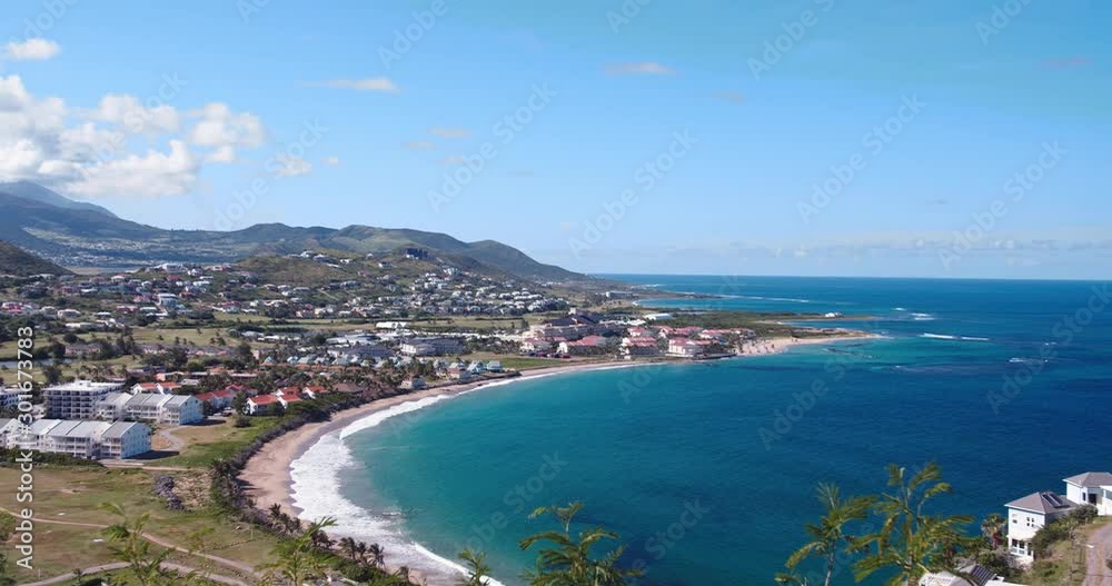 Slow pan shot of beautiful Frigate Bay in St. Kitts overlooking the tranquil blue ocean, hotels, gold course and homes in the distance Slow pan shot of beautiful Frigate Bay in St. Kitts overlooking the tranquil blue ocean, hotels, gold course and homes in the distance