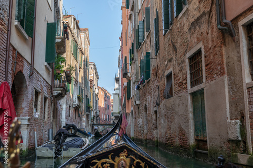 Panoramic view of Venice narrow canal with historical buildings from gondola