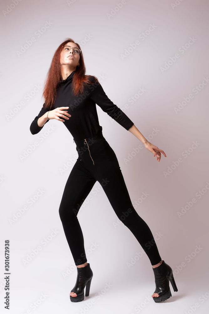 Fashion portrait of woman in  studio. High Fashion model girl in  stylish clothes posing in studio, portrait of beautiful woman, model posing training