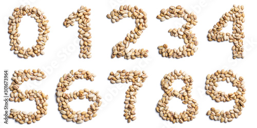 Arabic numerals from an unpeeled pistachios on a white isolated background. Unpeeled pistachios pattern. healthy food concept. Letters for composing texts