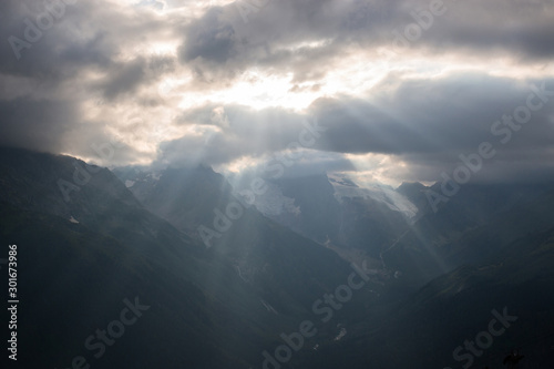 Panorama of misty mountains scene with dramatic sky in national park of Dombay © TravelFlow