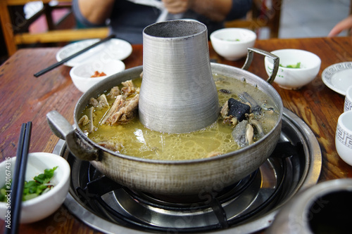 Lijiang Preserved Spare Ribs Hotpot, Yunnan. Yunnan-style hot pot broth is clear and light, bubbling with choice of smoked pork ribs or chicken.