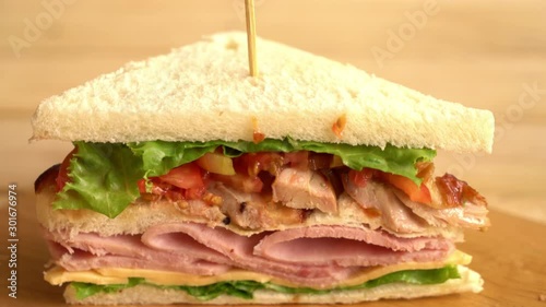 chiciken and ham sandwich on wood board photo