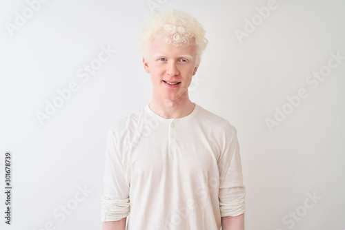 Young albino blond man wearing casual t-shirt standing over isolated white background with a happy and cool smile on face. Lucky person.