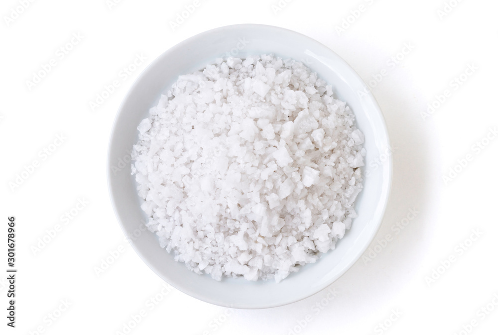 Closeup coarse or rock natural sea salt in brown bowl isolated on white background. Clipping path. Top view.	