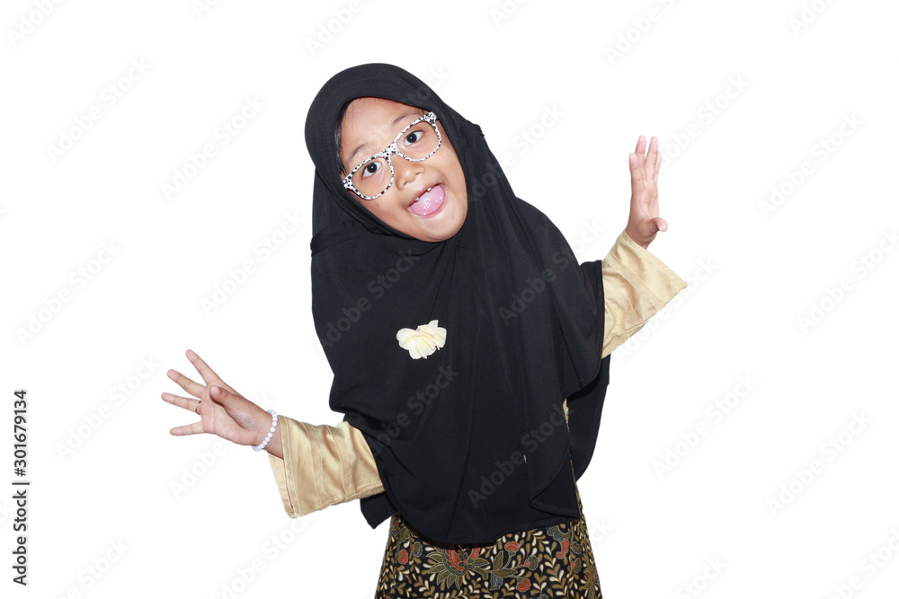 Portrait of cute A young asian little girl 6-7 years old muslim, wearing hijab, show face expression Portrait of cute A young asian little girl 6-7 years old muslim, wearing hijab, show face expression