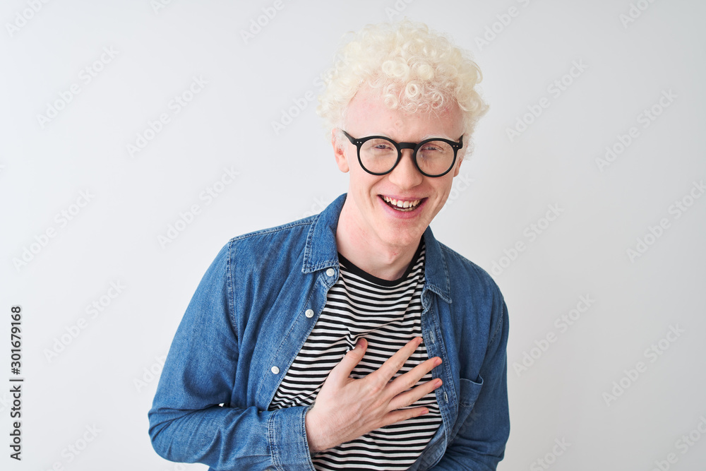 Young albino blond man wearing denim shirt and glasses over isolated white  background smiling and laughing hard out loud because funny crazy joke with  hands on body. Stock Photo | Adobe Stock