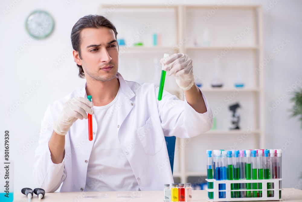 Young male chemist working in the lab