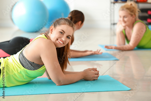 Body positive women resting after training in gym