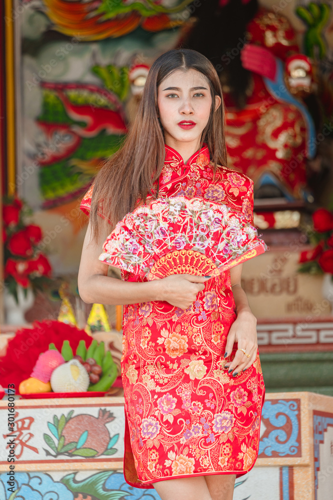 Portrait of beautiful asian woman in Cheongsam dress,Happy Chinese new year concept