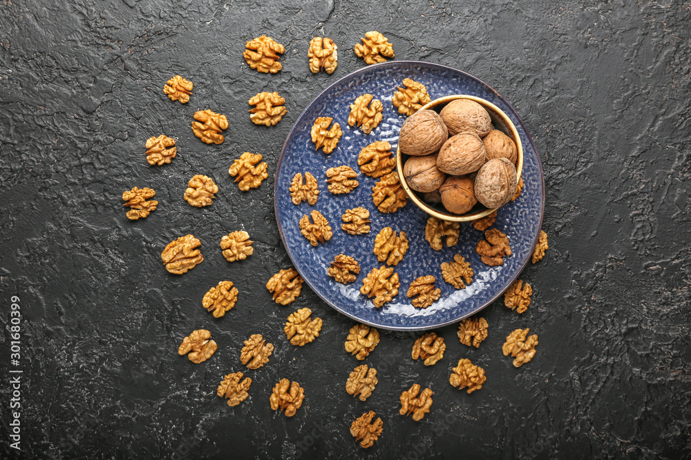 Composition with tasty walnuts on dark background