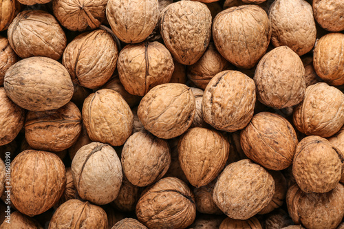 Many tasty walnuts as background