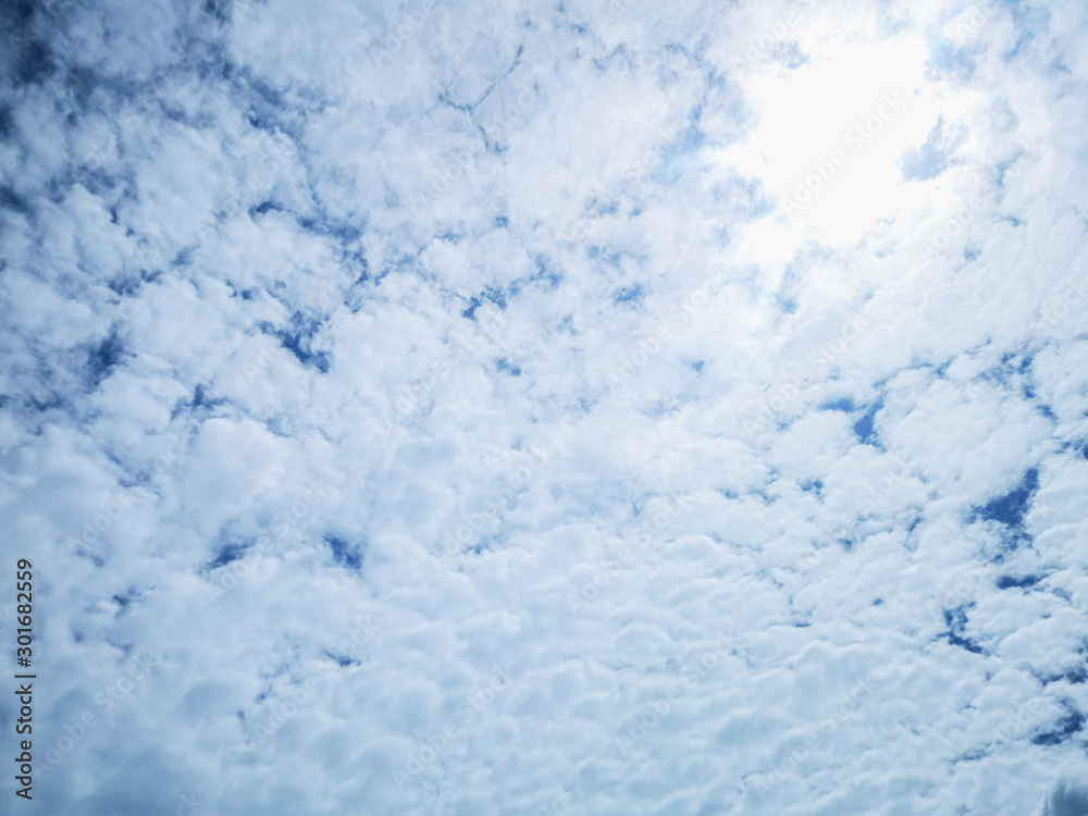 Cloudscape with fluffy white clouds blue sky  and sunlight abstract nature background.