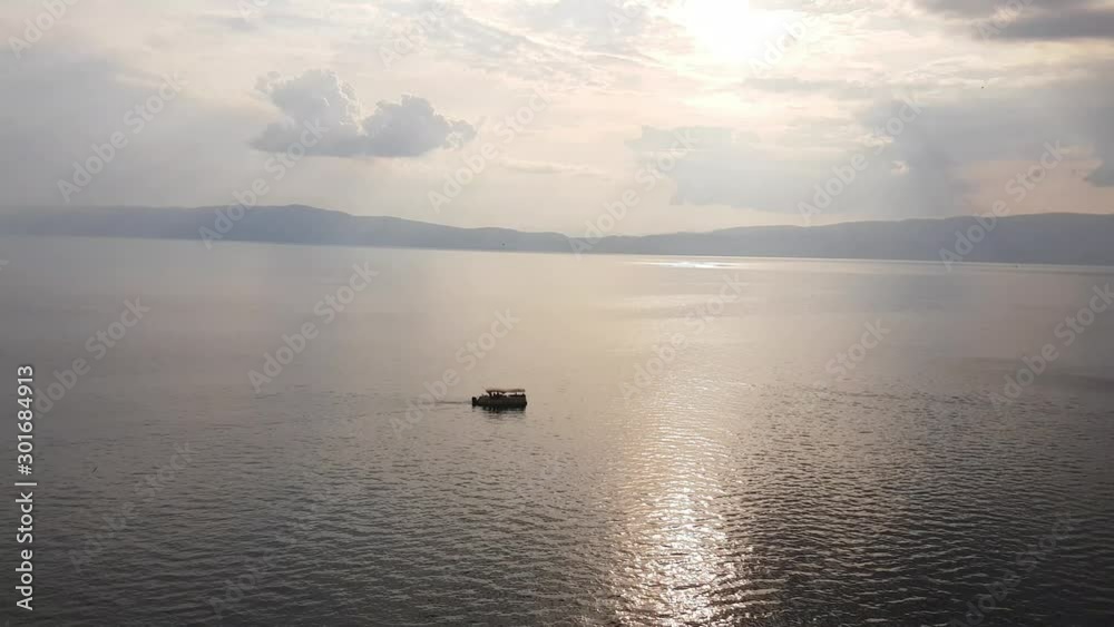 Beautiful light reflects on Lake Ohrid, Macedonia, small boat on water Beautiful light reflects on Lake Ohrid, Macedonia, small boat on water