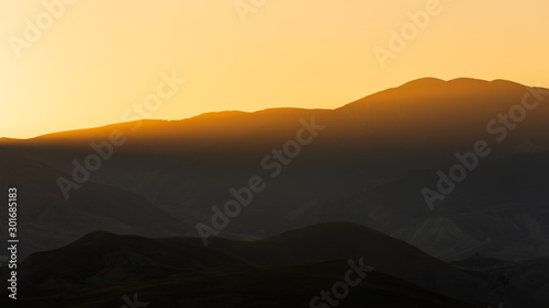 Silhouetted mountain range after sunset