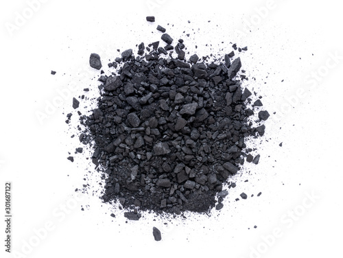 Pile of granular black activated charcoal  isolated on white background. Top view. Flat lay. photo