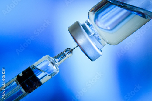 Close up of flu and measles vaccine vials for baby caccination, medicine and drug concept photo