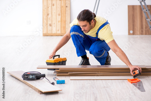 Young male contractor working indoors
