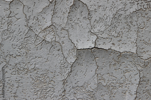Heavily cracked stucco that has begun to delaminate from its substrate  photo