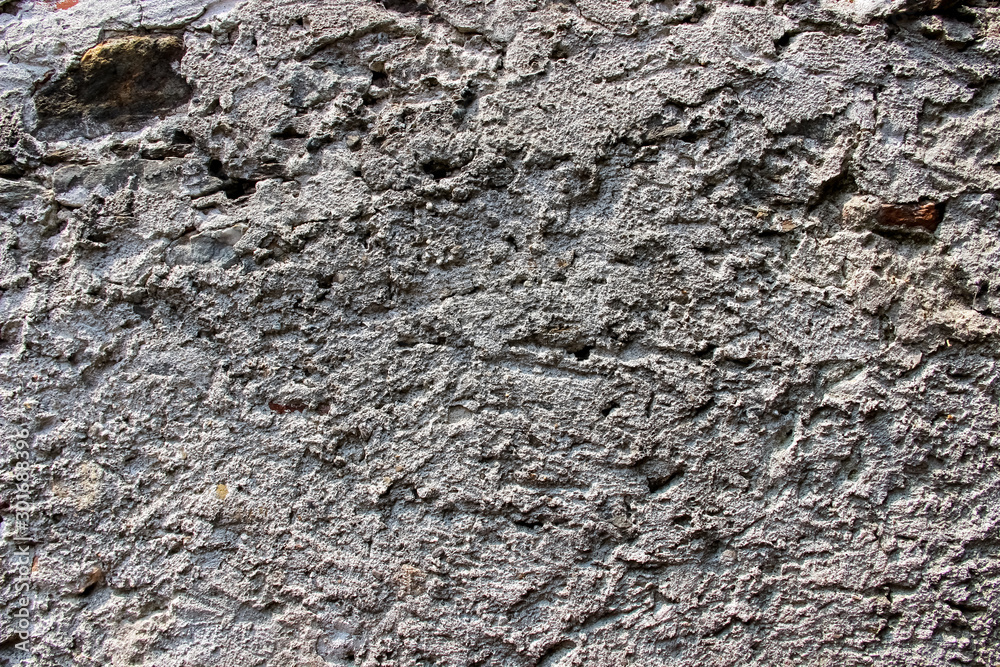 Texture of an old damaged wall coated with thick layer of cement Texture of an old damaged wall coated with thick layer of cement