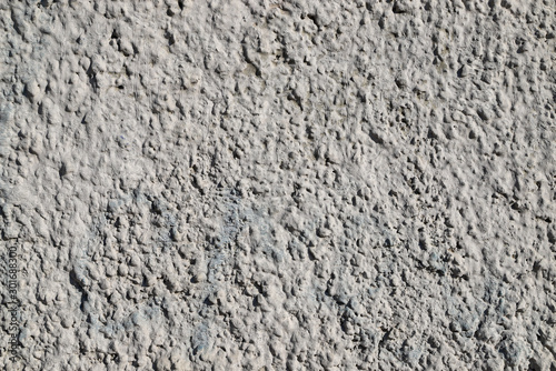 Texture of a wall plastered with cement painted in gray