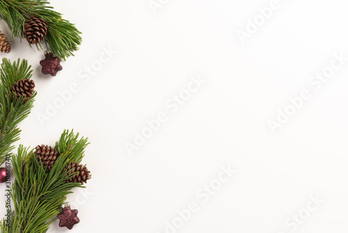 Christmas composition. Spruce branches with cones and christmas decorations, on a white background. Christmas, winter, new year concept. Flat lay, top view, copy space.