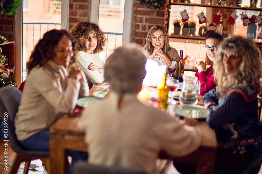 Beautiful group of women smiling happy and confident. Eating roasted turkey celebrating christmas at home Beautiful group of women smiling happy and confident. Eating roasted turkey celebrating christmas at home